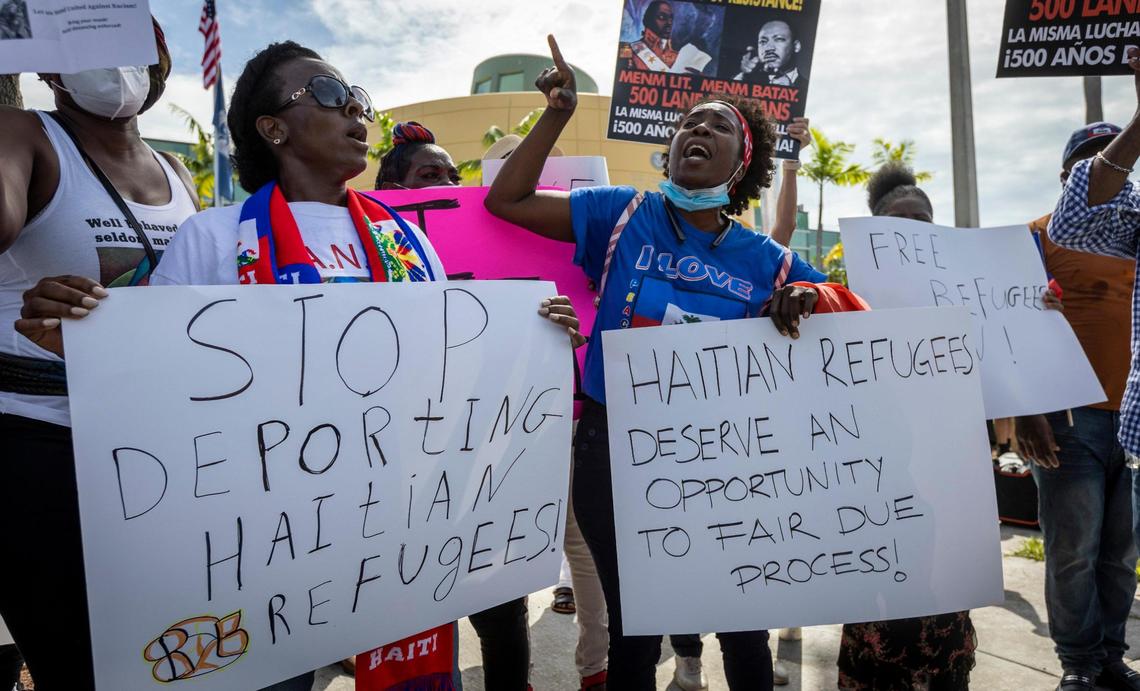 Firmante Peters, left, and Santcha Etienne chant slogans in front of the USCIS district office at 8801 NW 7th Ave. in September 2021, as members of the Haitian community in Miami protest the Biden administration’s handling of Haitian immigrants at the U.S.-Mexico border.