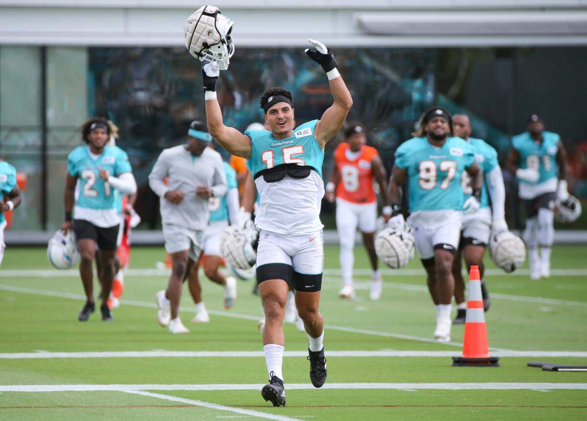 Miami Dolphins Jaelan Phillips motivates the fans as the team rushes the field for practice at Baptist Health Training Complex in Miami Gardens on Saturday, July 30, 2022.