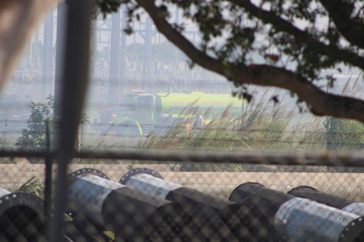 Miami-Dade firefighters battle a grass fire near Miami Executive Airport. Heavy smoke prompts warnings for those with respiratory conditions.