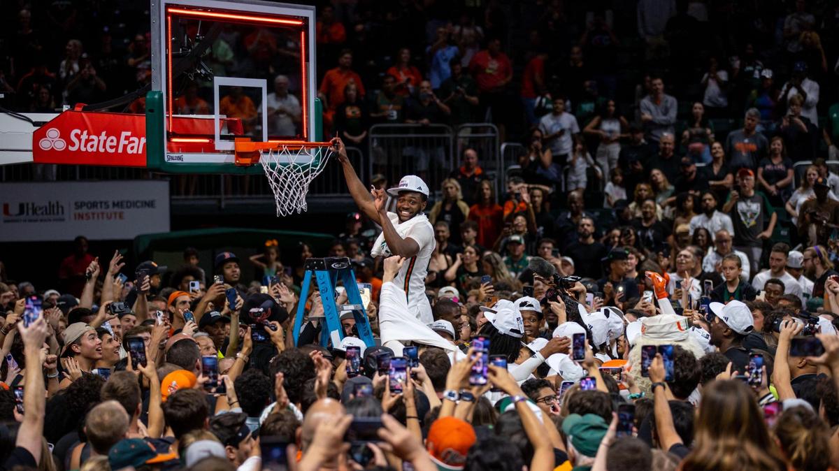 Hurricanes guard Wooga Poplar cuts the hoop after defeating the Pittsburgh Panthers 78-76 to become regular season Co-Champs and the first seed for the ACC Tournament during an NCAA basketball game at Watsco Center in Coral Gables, Florida, on Saturday, March 4, 2023.
