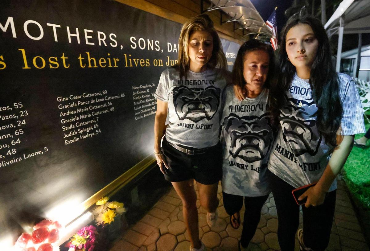 Adrianna Lafont, Ivonne Lafont Villagra, and Mia Lafont, left to right, visit the memorial wall at Veterans Park across from the site of the Champlain Towers South collapse in Surfside, Florida. The three attended the Second Annual Remembrance Ceremony in honor of their relative Manny Lafont on Saturday, June 24, 2023.
