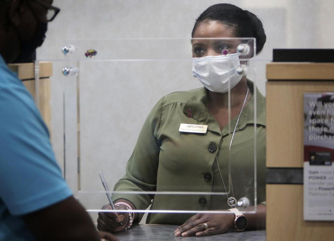 Homestead, Florida, October 8, 2020- Bernadette Gissendanner, a teller at Power Financial, takes care of a customer. Earlier this year, Power Financial Credit Union decided to implement a $15 minimum at all its branches in solidarity with workers.