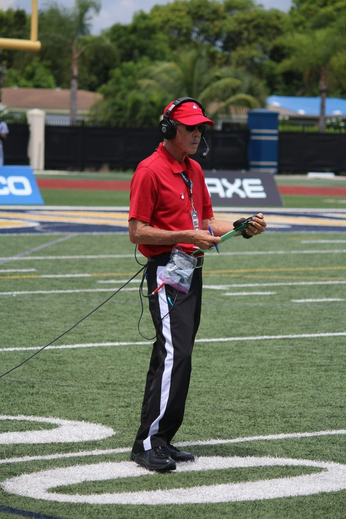 Longtime referee Joe Underwood works as the TV timeout coordinator for ESPN during a recent nationally-televised high school football game between St. Thomas Aquinas and St. Joseph’s Prep. Underwood was recently inducted into the FHSAA Hall of Fame.