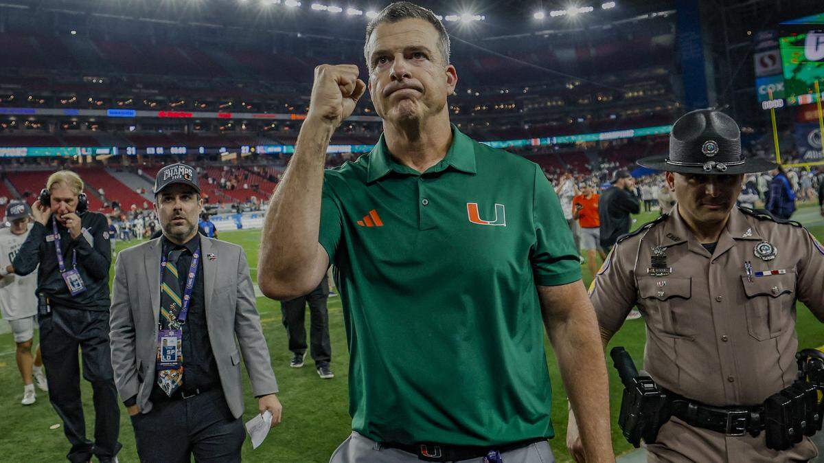 Miami Hurricanes head coach Mario Cristobal pumps his fiest as he leaves the field] College Football Playoff semifinal against the Mississippi Rebels in the Fiesta Bowl at State Farm Stadium on Friday, January 9, 2026 in Glendale, Arizona.