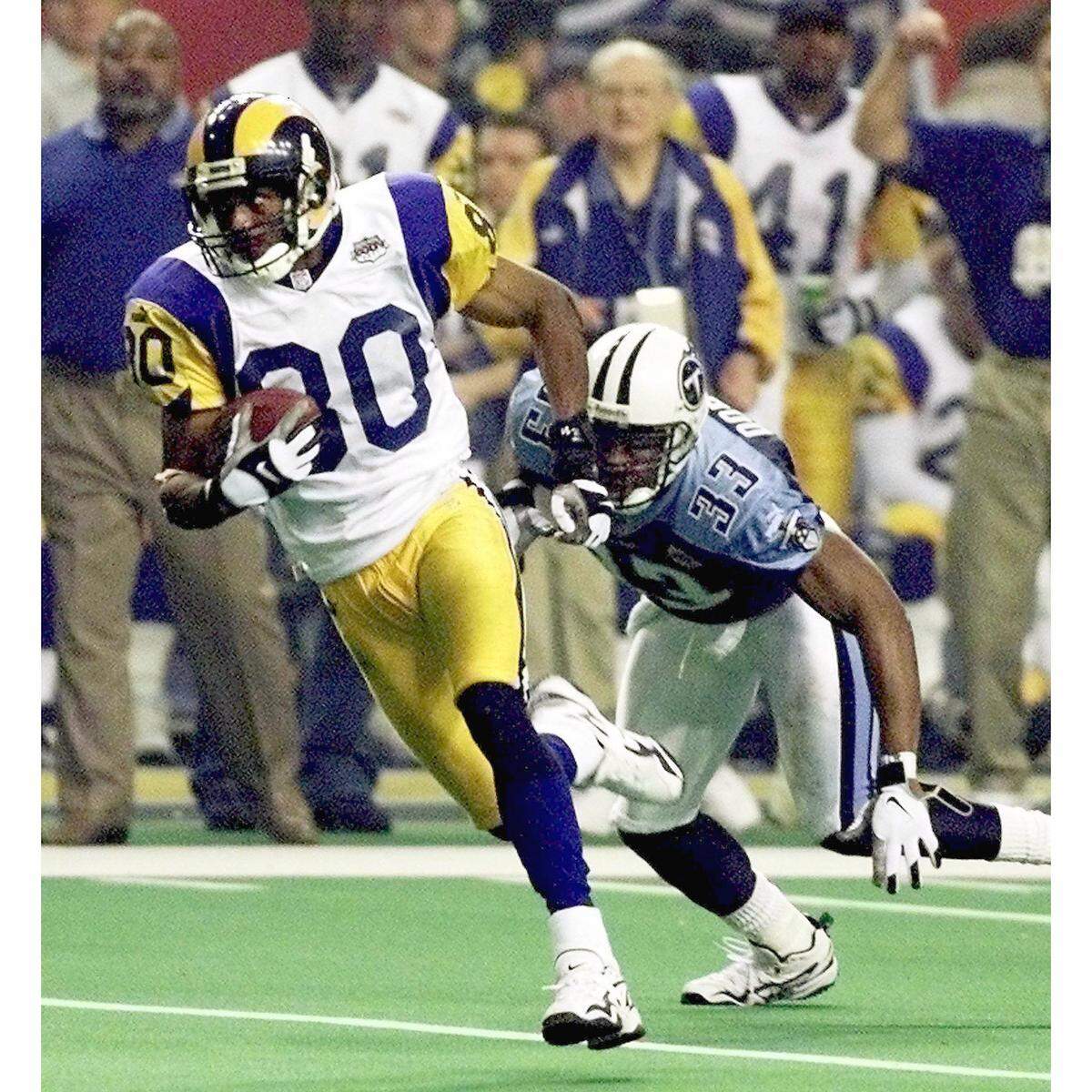 Rams wide receiver and Fort Lauderdale Dillard graduate Isaac Bruce takes off with the 73-yard touchdown that proved to be the winning score in the Rams 23-16 Super Bowl XXXIV win against Tennessee. Titans cornerback Anthony Dorsett, son of Hall of Fame running back Tony Dorsett, is in pursuit.