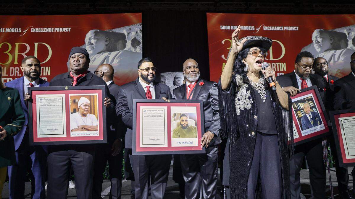 2026 Headliners Maurice “Trick Daddy” Samuel Young, left, Khaled “ DJ Khaled” Mohammed Khaled, Reginald A. “Strongman” Mathis, ESQ., right, and others hold their Congressional Record given by Congresswoman Frederica S. Wilson. The 5000 Role Models held its 33rd Annual Dr. Martin Luther King, Jr. Annual Scholarship Breakfast with Keynote Speaker Bishop Neil C. Ellis, and the 2026 Headliners consisting of Lee “Freezy Prince” Prince, Tramar “Flo Rida” Lacel Dillard, Maurice “Trick Daddy” Samuel Young, and Khaled “ DJ Khaled” Mohammed Khaled, on Monday, January 19, 2026, at the Miami Beach Convention Center, in Miami Beach, Florida.