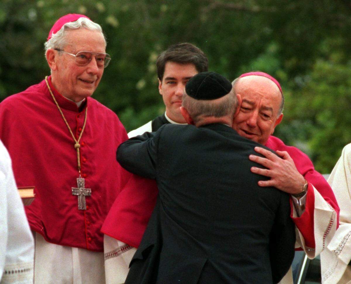 Miami Archbishop John Clement Favalora is greeted by Rabbi Solomon Schiff, executive director of the Rabbinical Association of Greater Miami, prior to his installment ceremonies at St. Mary’s Cathedral on Dec. 20, 1994. Outgoing Archbishop Edward McCarthy looks on at left.
