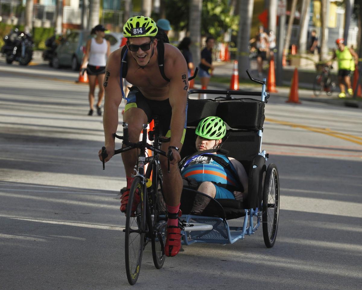 Members of Team Special Compass head out for the cycling stage of the Mack Cycle Escape to Miami Triathlon on Sunday, Sept. 30, 2018, where the start and finish are in Margaret Pace Park in Miami, Florida.
