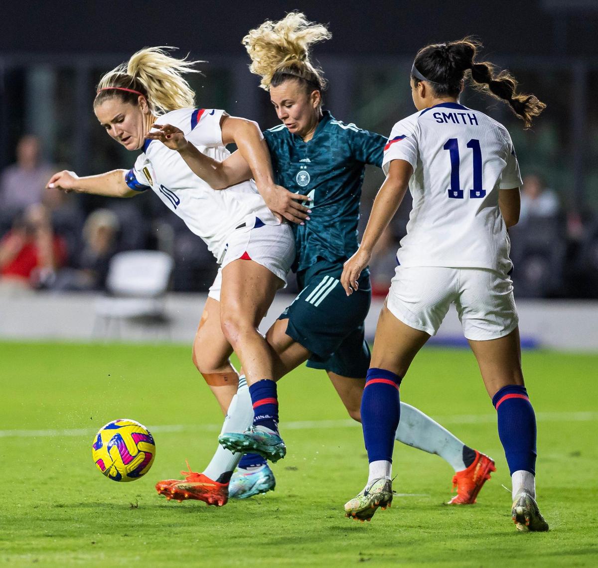 United States midfielder Lindsey Horan (10) fights for possession of the ball against Germany midfielder Lena Lattwein (14) during the second half of an international friendly soccer match at DRV PNK Stadium on Thursday, Nov. 10, 2022, in Fort Lauderdale, Fla.