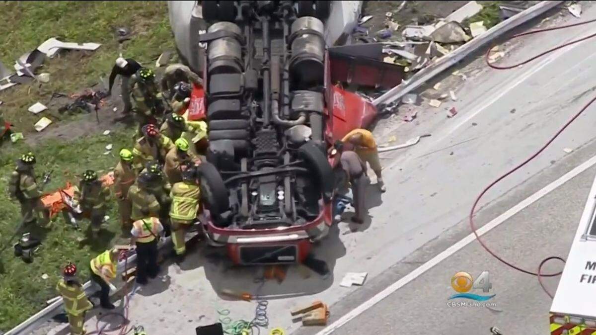 Miami-Dade rescue crews work to pull the body from a tractor-trailer that overturned on the Florida Turnpike Tuesday afternoon, Aug. 7, 2018.