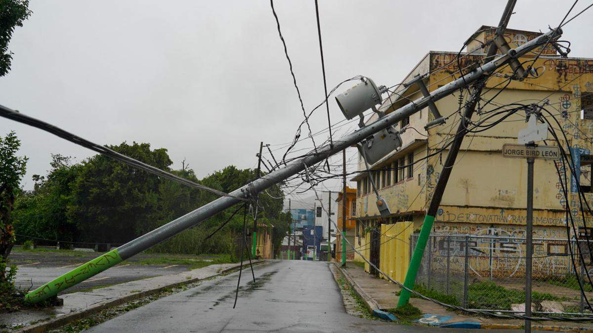 Broken electricity lines above homes after Tropical Storm Ernesto hit Fajardo, Puerto Rico, on August 14, 2024. Photo by JAYDEE LEE SERRANO/AFP via Getty Images