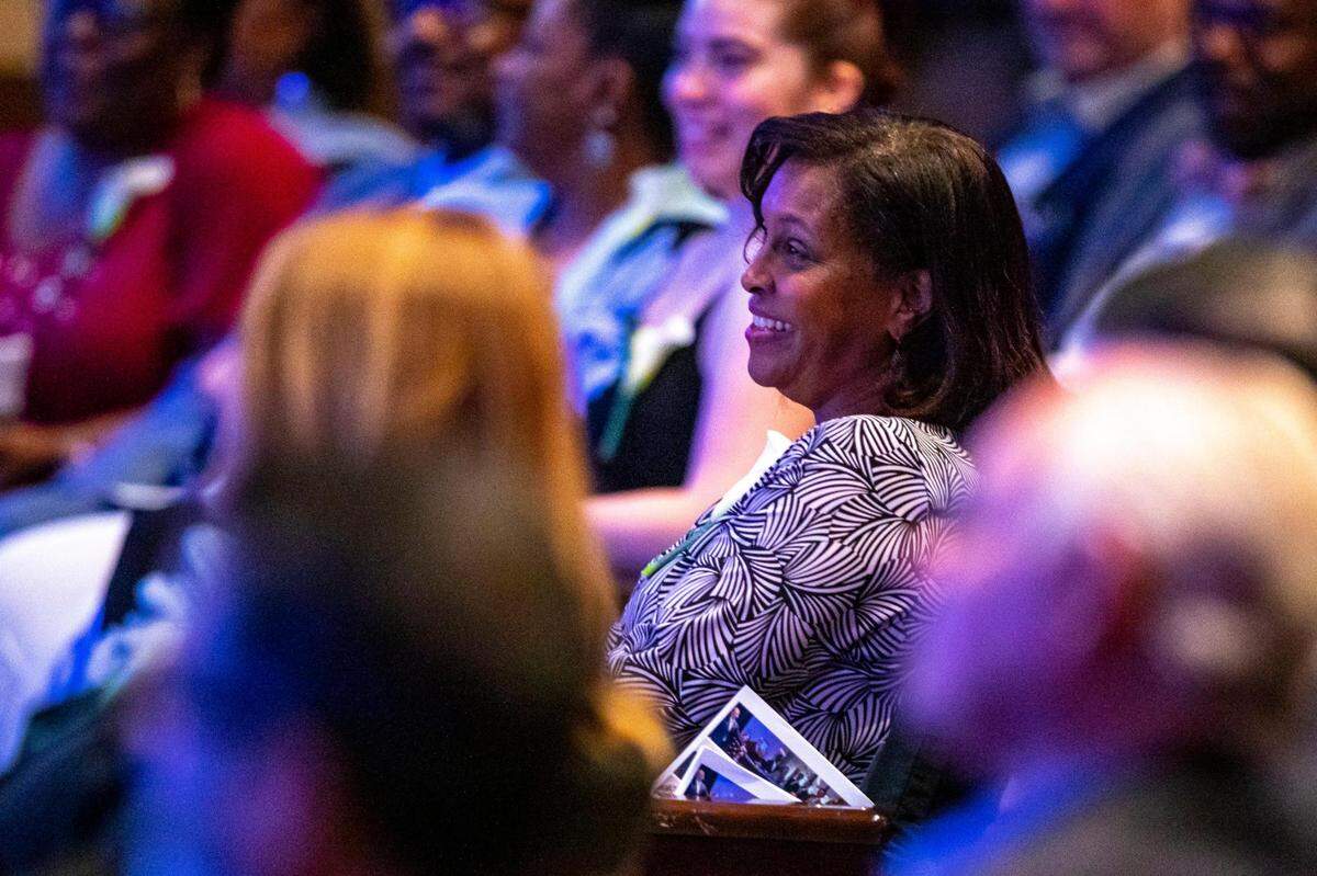 Gina Finney reacts to strories being told about her late husband during a memorial service for Michael A. Finney, president and CEO of the Miami-Dade Beacon Council, at Miami Dade College, Wolfson Campus in downtown Miami, Florida, on Monday, April 25, 2022.