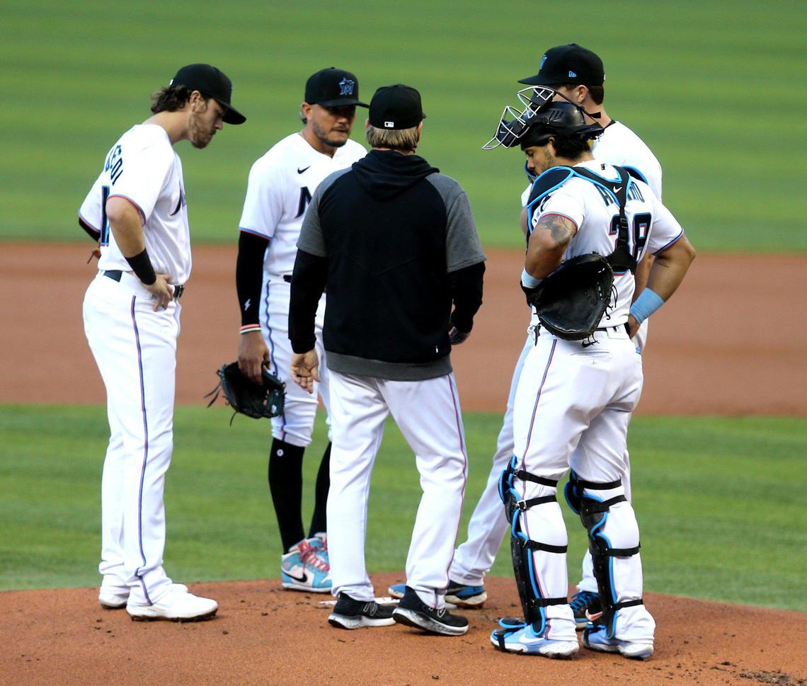 Miami Marlins pitching coach Mel Stottlemyre Jr. talks with players on the mound in the first inning as they play the St. Louis Cardinals at loanDepot park in Miami, Florida, Monday, April 5, 2021.