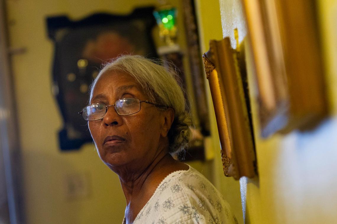 Herminia Rivera (checking) lives in a home in Barriada Bitumur in San Juan, Puerto Rico where the roof leaks because of severe damage from Hurricane Maria on August 24, 2018.