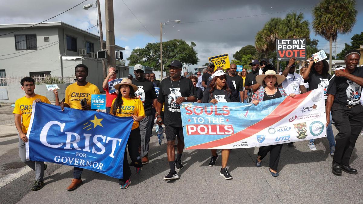 Karla Hernandez, running for Lieutenant Governor, Mayor Daniella Levine Cava, and other political and religious leaders march down NW 22nd Avenue during a Souls to the Polls event on Sunday, Nov. 6, 2022, in Liberty City, Miami. The march started at the African Heritage Cultural Arts Center and ended at the polling place at the Joseph Caleb Center.