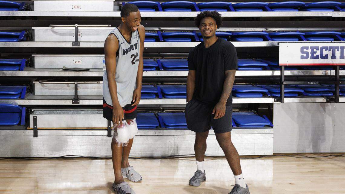 Andrew Wiggins (22) laughs with Davion Mitchell (45) during the first day of Miami Heat Training Camp on Sept. 30, 2025, at Florida Atlantic University in Boca Raton.