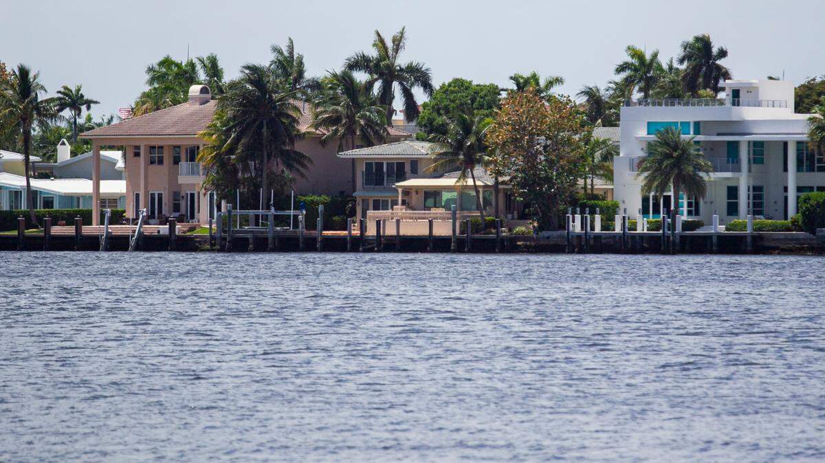 Millions of homeowners are expected to pay more for their homeowners insurance. Above: Houses sit off Lake Santa Barbara in Pompano Beach, Florida, on Monday, April 26, 2021.