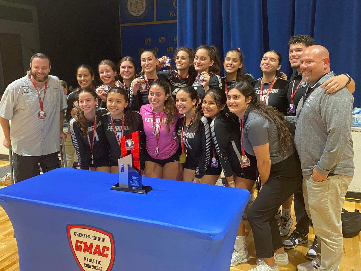 Ferguson’s girls’ volleyball team celebrates its second consecutive GMAC championship following a win over Miami High in the final on Tuesday night at Miami-Dade College’s Kendall campus.