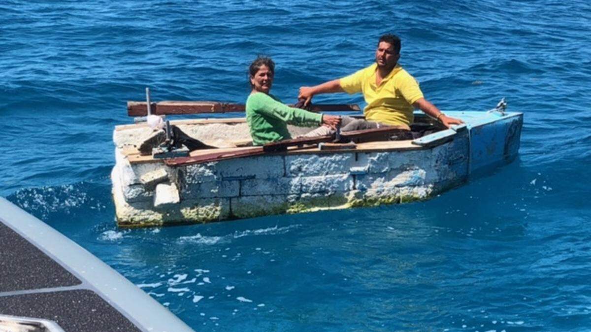 A man and woman from Cuba sit in a makeshift Styrofoam raft offshore of Key Largo Tuesday, May 5, 2021.