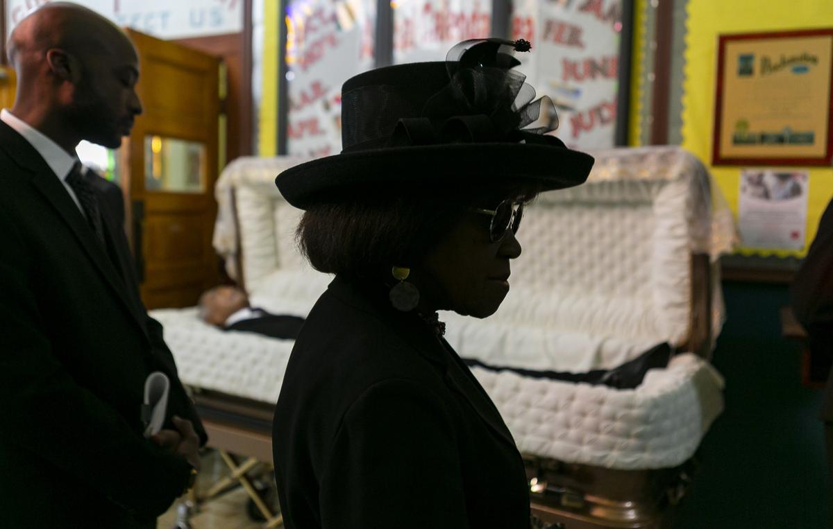 WenDell Neal, center, waits in line to sign the guest book during the funeral Mass for The Miami Times publisher Garth C. Reeves Sr. at the Historic Saint Agnes Episcopal Church in Miami on Friday, Dec. 6, 2019.