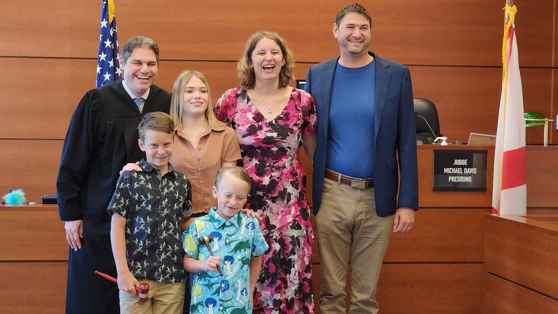 Dr. Mary Kinirons, executive director of the Heart Gallery of Broward County, and her husband, Bill Kinirons, to her right, celebrates the adoption of their three children, Kadence Sullivan-Kinirons, 18, David, 10, and Brody, 7, with Broward Circuit Court Judge Michael Davis.