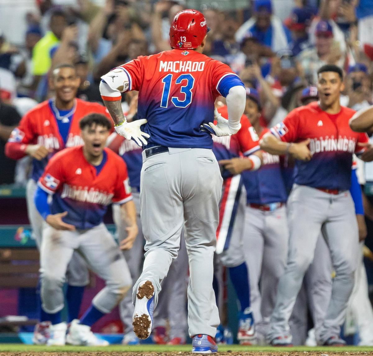 Dominican Republic third baseman Manny Machado (13) celebrates with his teammates after hitting a home run against Nicaragua during the seventh inning of a Pool D game at the World Baseball Classic at loanDepot Park on Monday, March 13, 2023, in Miami, Fla.