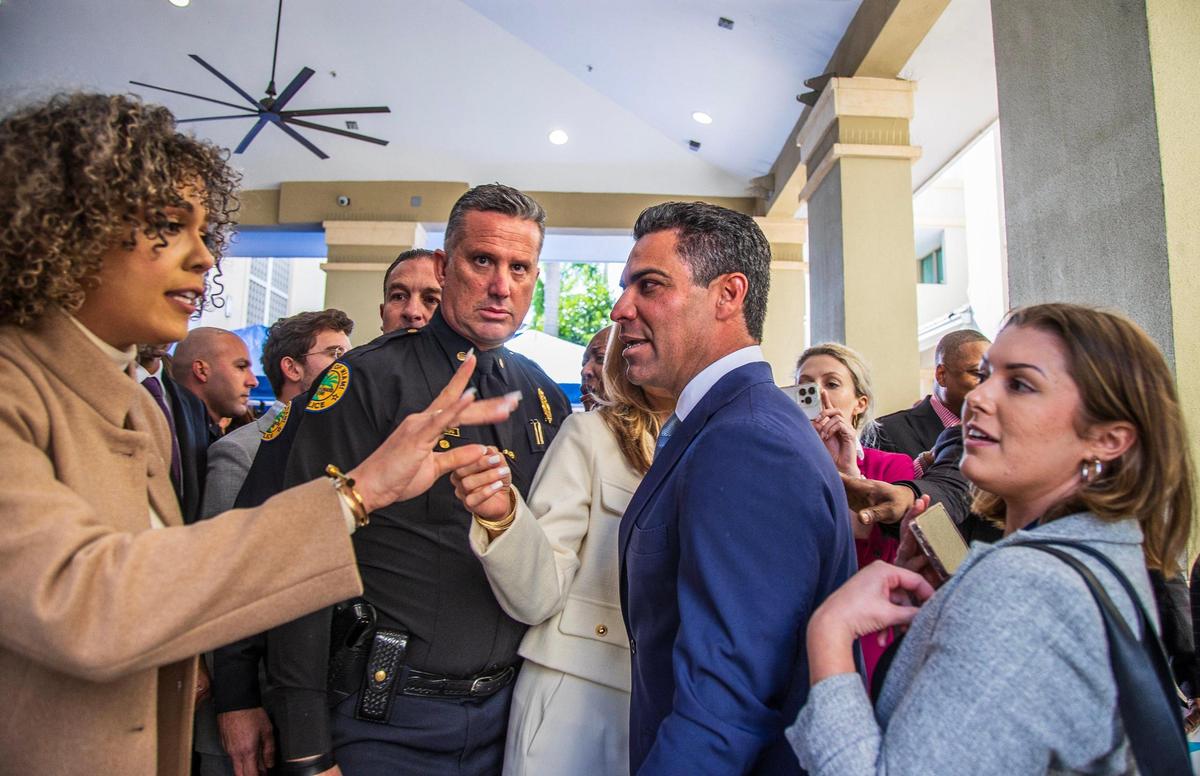 Stephanie Severino, left, director of communications for Miami Mayor Francis X. Suarez, center right, shields the mayor from Herald reporter Tess Riski, right, after his State of the City address.