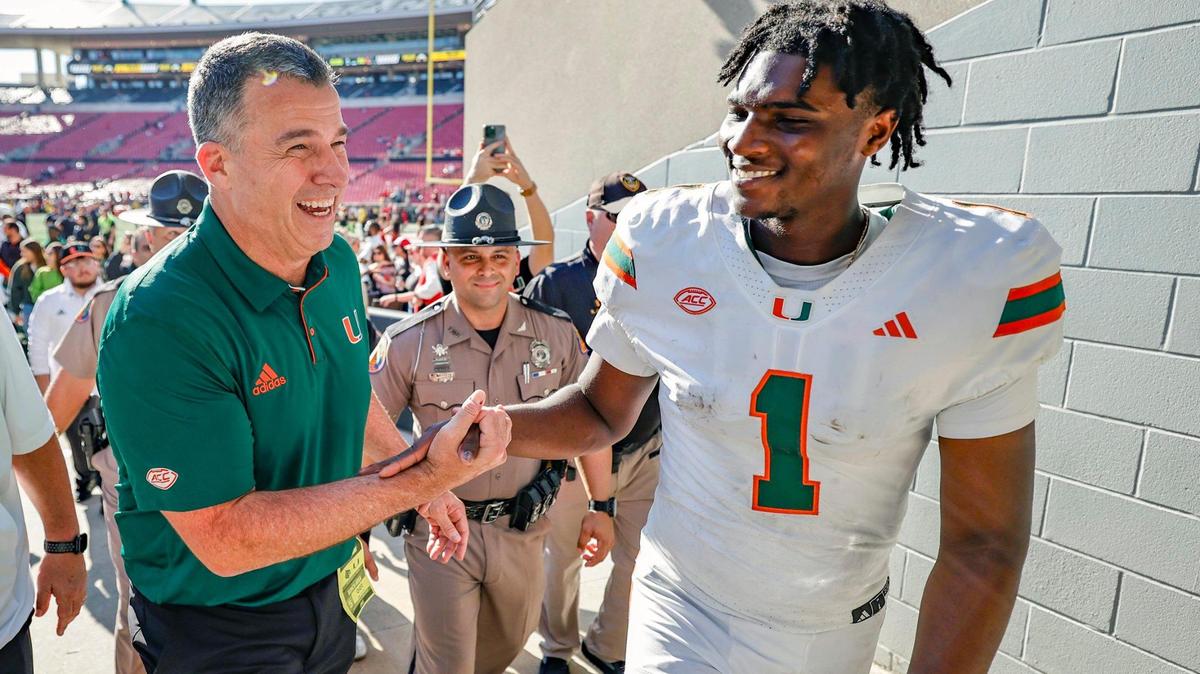 Miami Hurricanes head coach Mario Cristobal and quarterback Cam Ward (1) celebrate the win against the Louisville Cardinals after an NCAA football game at L&N Federal Credit Union Stadium in Louisville, Kentucky on Saturday, October 19, 2024.