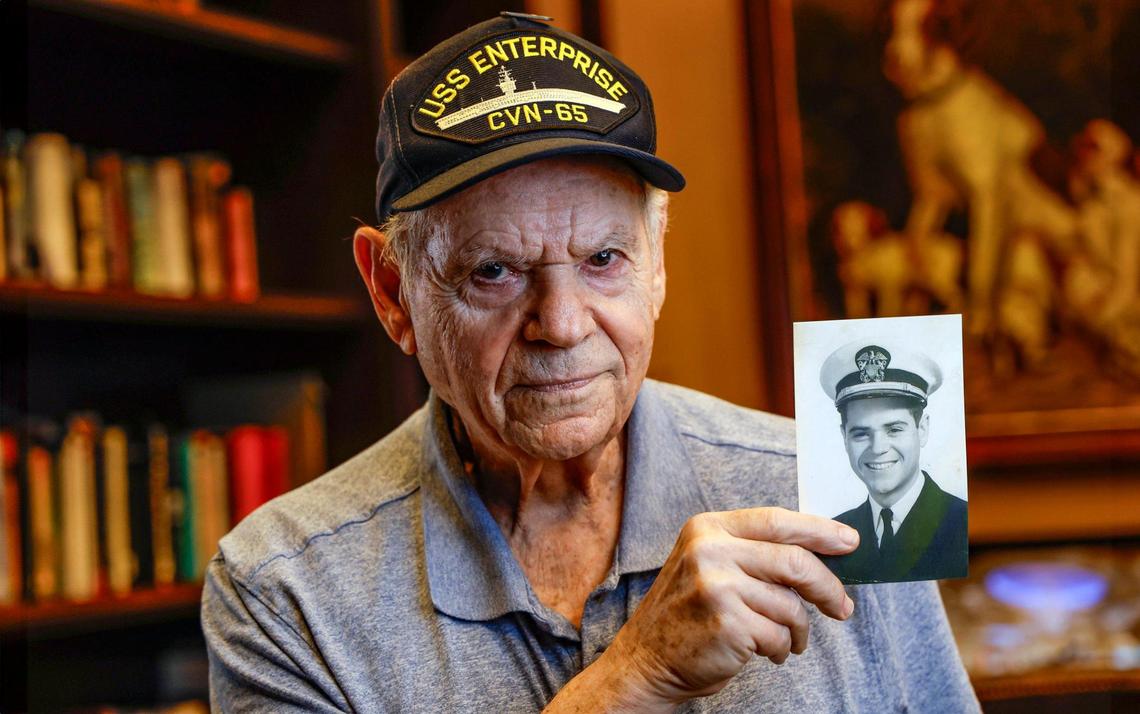 Dr. Jay Ellenby, 89, on Thursday, Nov. 7, 2024, holds a portrait of himself when he was serving in the U.S. Navy. He now lives at The Palace in Coral Gables, Florida.