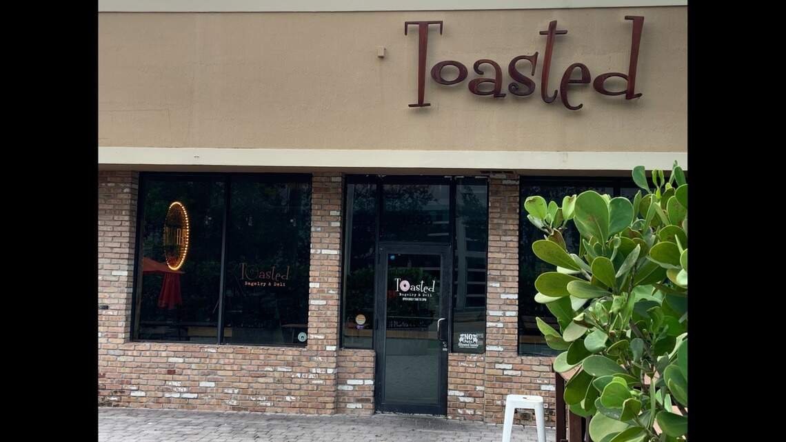 A fly on food and ‘soiled’ food containers at a Miami bagel place bordering Coral Gables