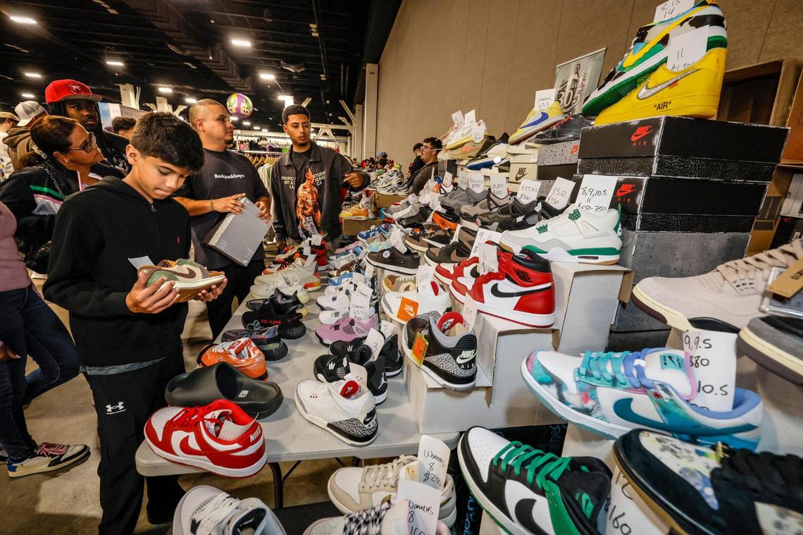 Shahmir Ahmad, 11, sorts through a table of rare footwear during Sneaker Con at the Broward County Convention Center in Fort Lauderdale, Florida, on Saturday, Jan. 11, 2025.
