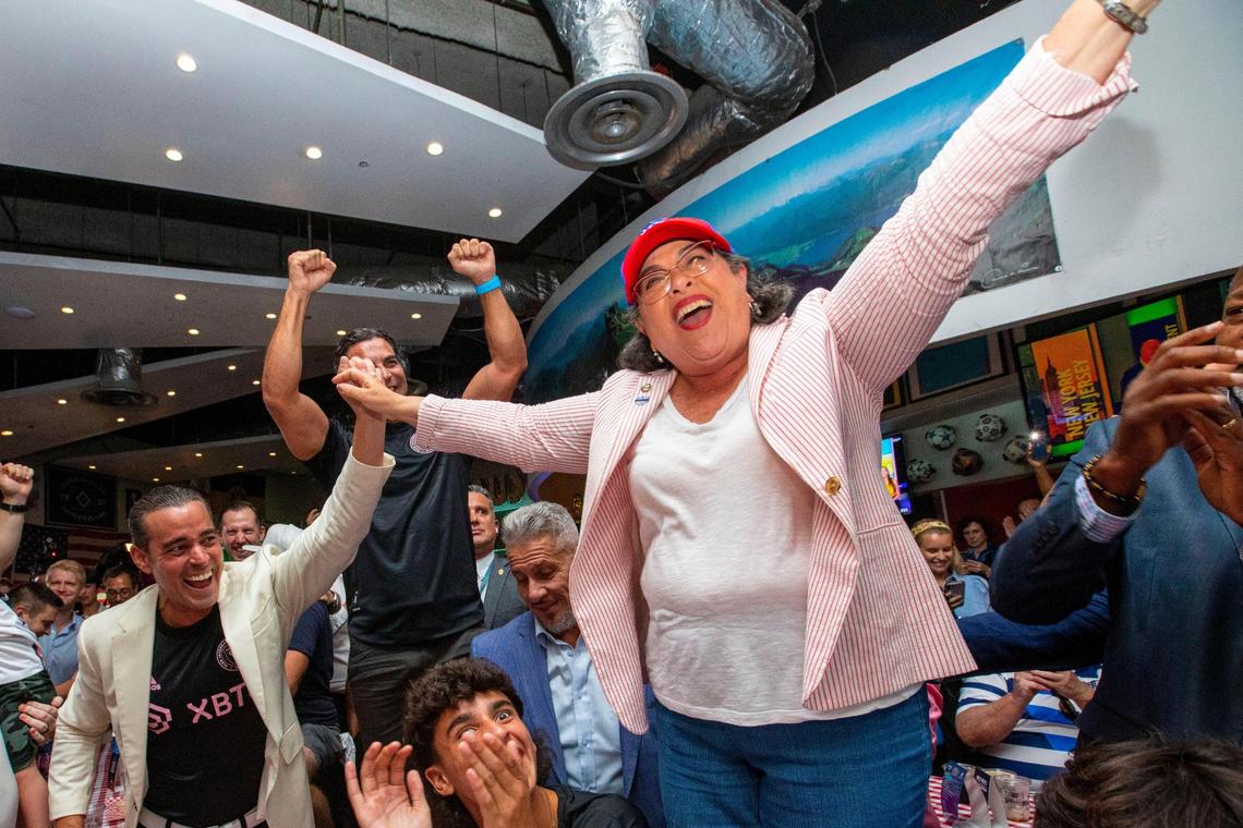 Mayor of Miami-Dade County Daniella Levine Cava, right, and Miami Mayor Francis Suarez, back left, react to Miami being selected as one of the cities for the FIFA 2026 World Cup venue during a watch party at Fritz & Franz Bierhaus in Coral Gables, Florida, on Thursday, June 16, 2022.