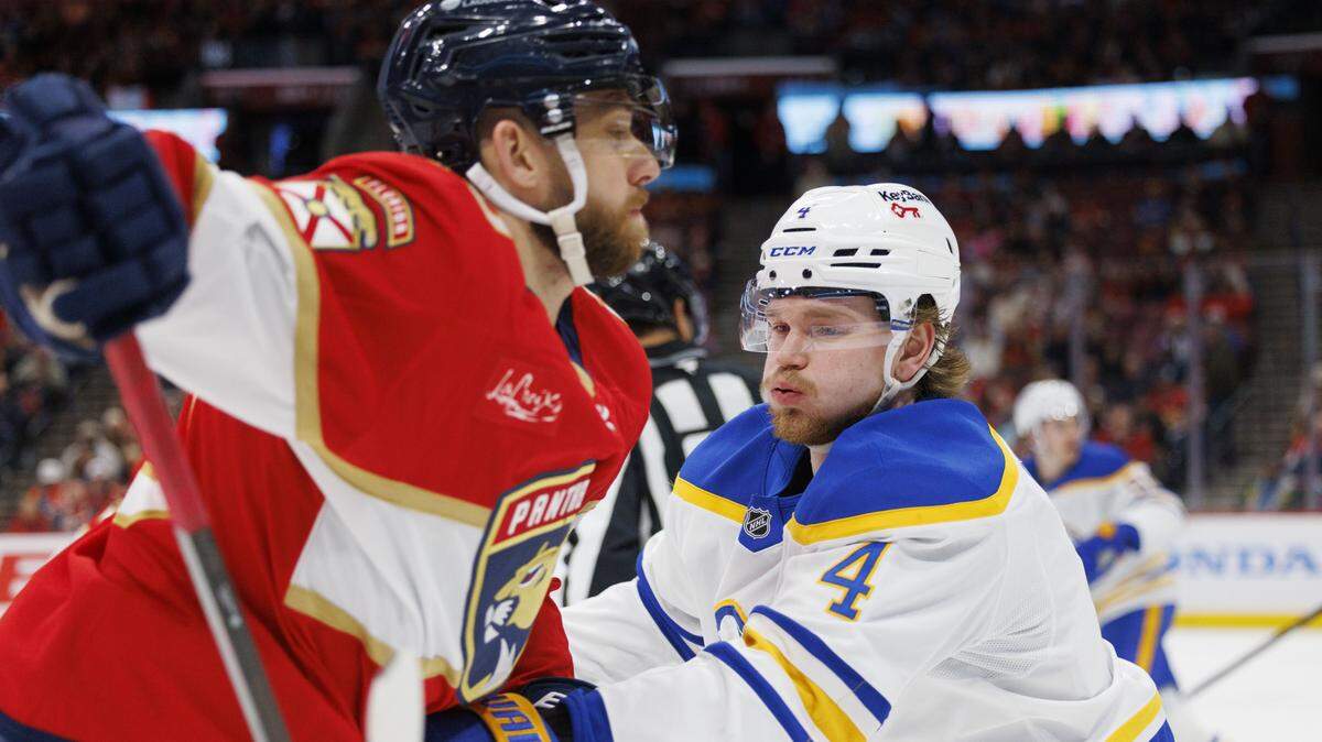 Buffalo Sabres defenseman Bowen Byram (4) and Florida Panthers left wing A.J. Greer (10) go after the puck during the first period of a game on Monday, Feb. 2, 2026, at Amerant Bank Arena in Sunrise, Fla.
