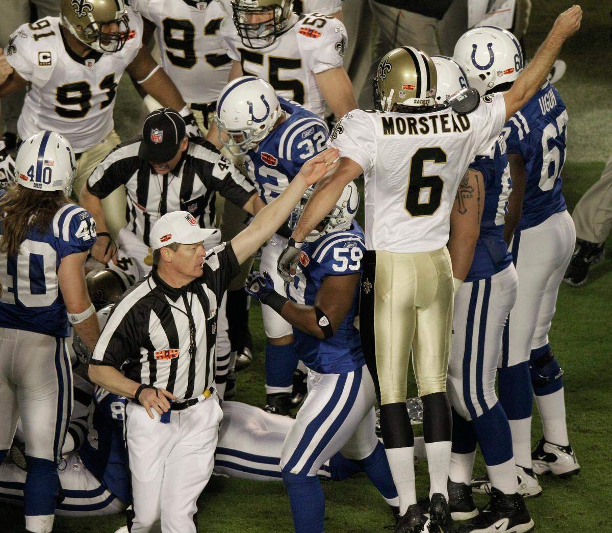 An official signals that the New Orleans Saints will have possession of the ball after an onside kick by Thomas Morstead (6) during the second half of the NFL Super Bowl XLIV football game on Feb. 7, 2010 against the Indianapolis Colts, in Miami. Sean Payton risked everything to start the second half of Super Bowl 44.
