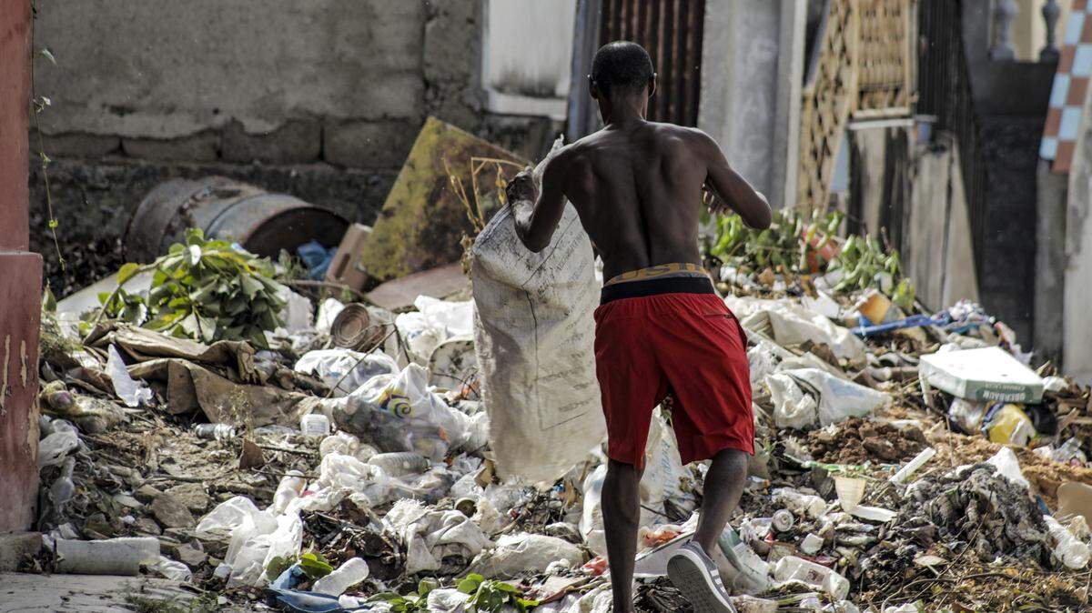A man disposes of waste at a collection point ahead of the arrival of Hurricane Melissa in Santiago de Cuba, Cuba, on October 27, 2025. Hurricane Melissa strengthened Monday as it took aim at Jamaica as a top-level Category 5 storm. (Photo by STRINGER/AFP via Getty Images)          