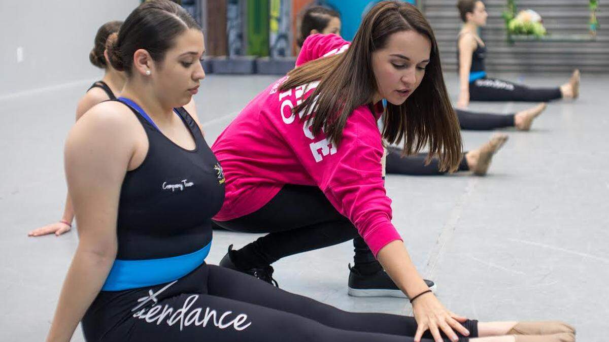 Valentina Bagala works with a student at her dance studio in Doral, Florida.