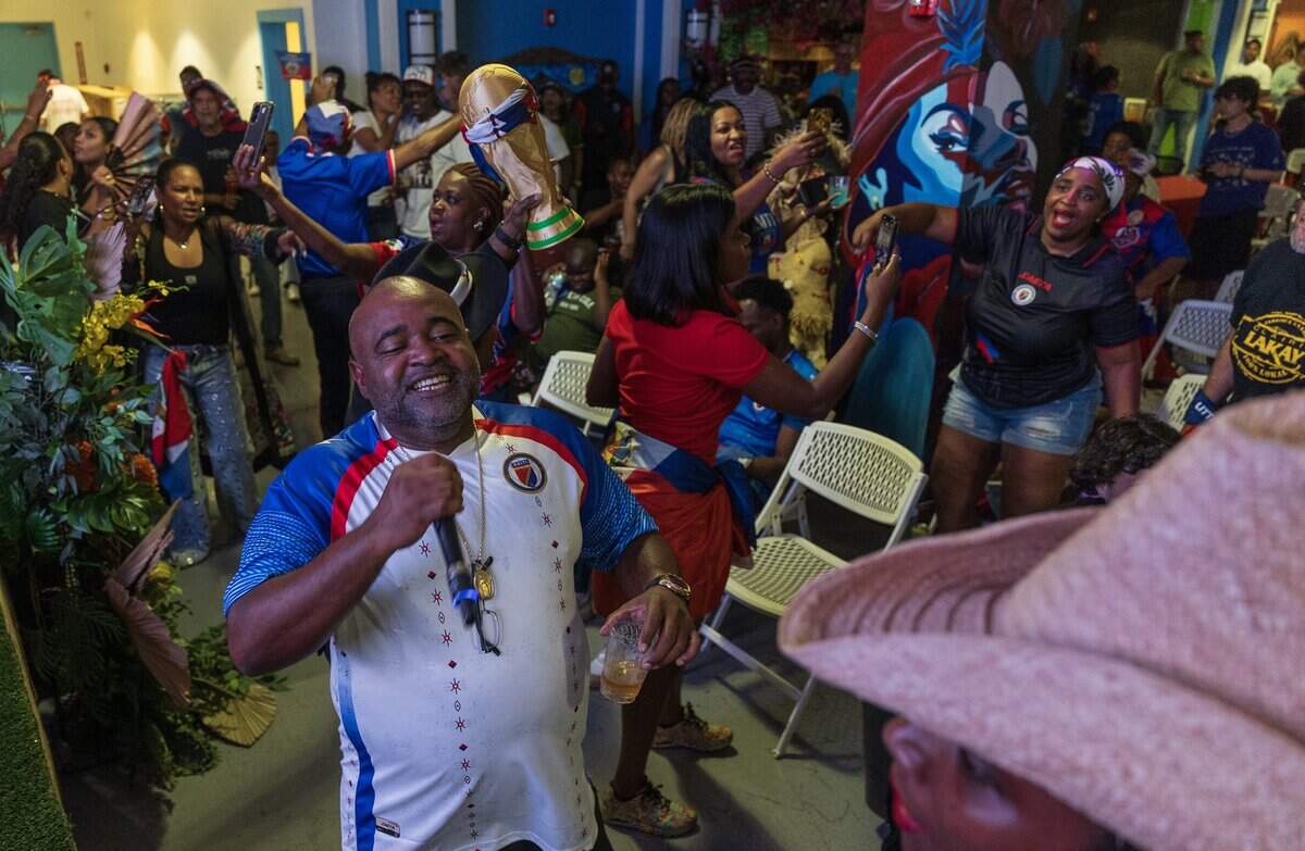 Haitian artist Morhanges Elize aka “Haitian Poohbear” signs during the halftime break of the Haiti vs. Scotland Fifa World Cup game, in Boston, at a game watch party at the Haitian Cultural Center in Little Haiti, on Saturday June 13, 2026.