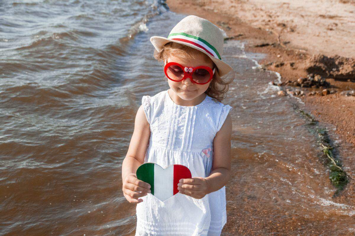 little girl holds heart-shaped italian flag