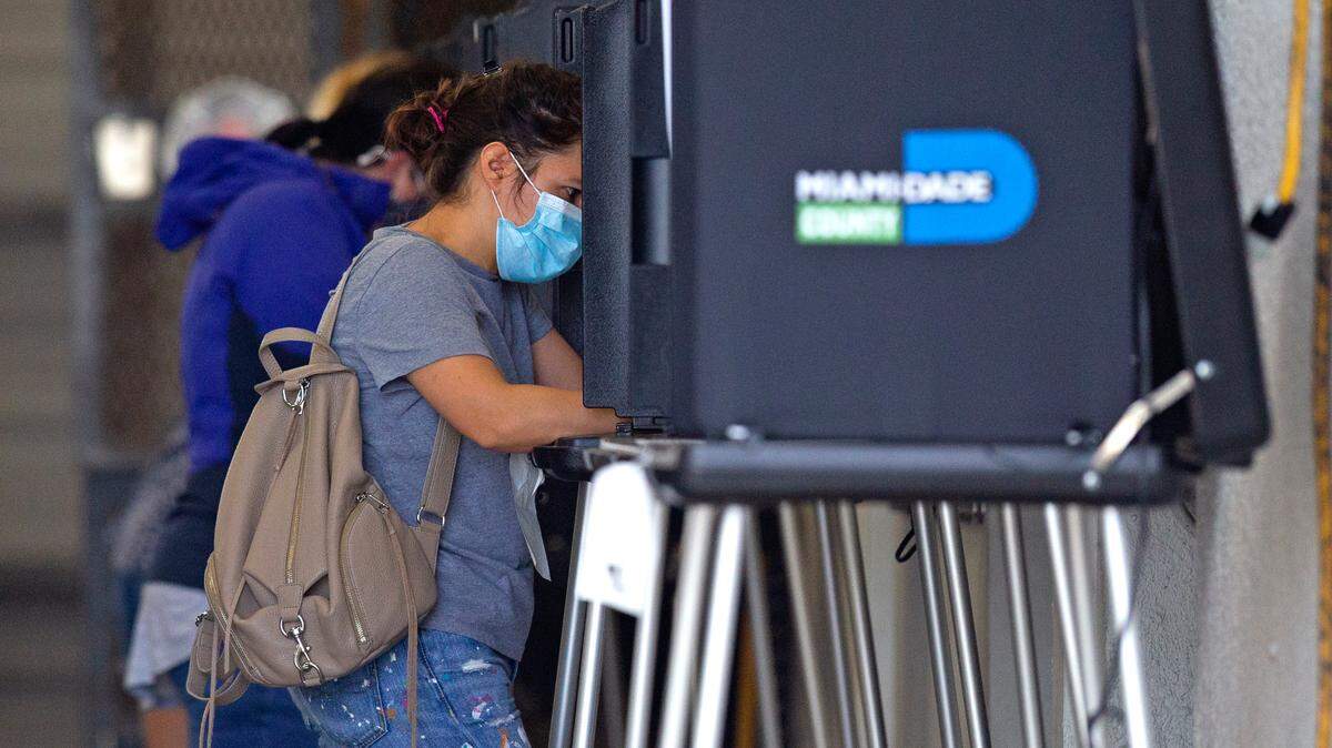 A group of people casting their votes during the general election in Miami-Dade County at Miami Beach Fire Department Station 3 on Tuesday, November 3, 2020.