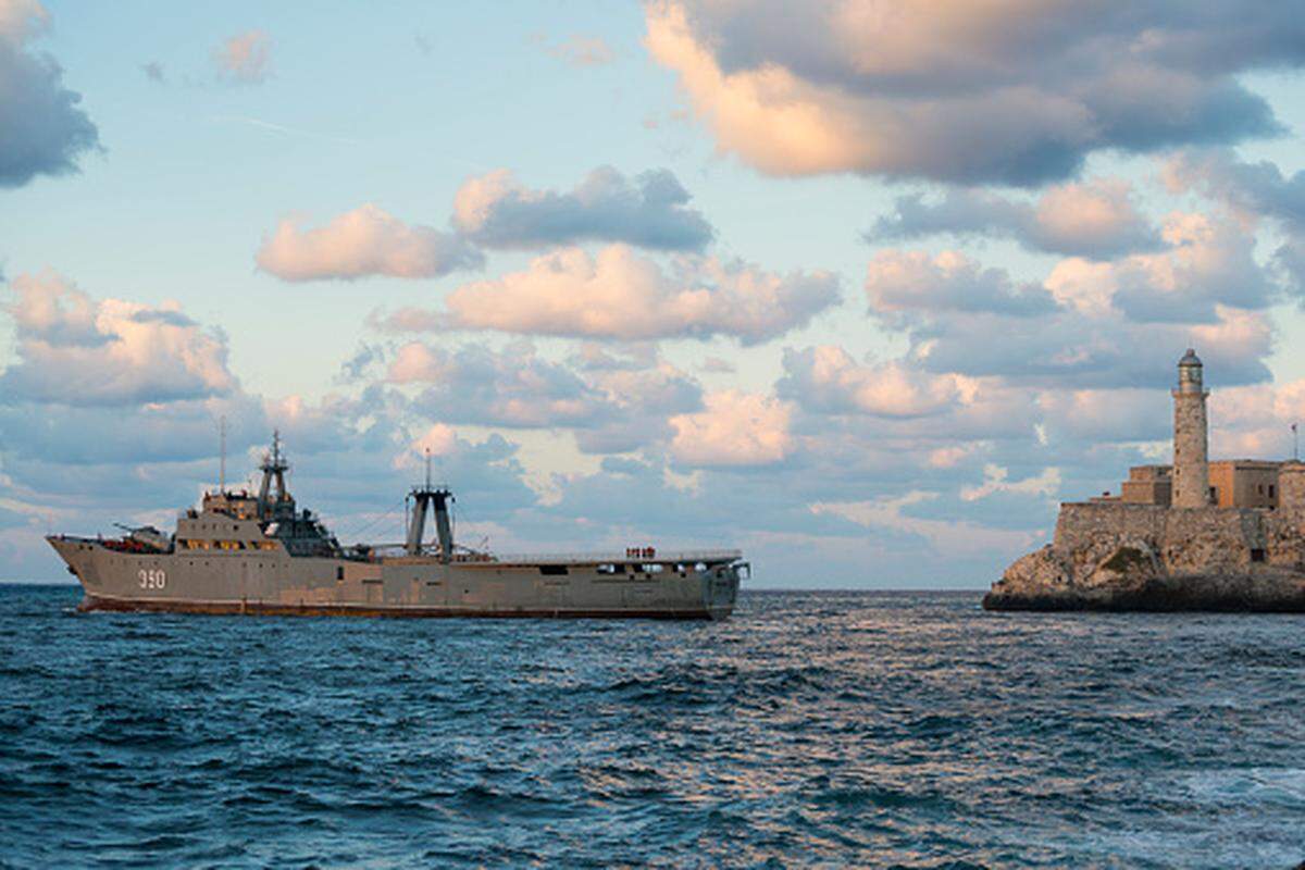 Cuban sailors stand on deck as their ship, a Rio Damuji class frigate, sails out of Havana Harbor in 2014. The largest warship in the Cuban navy, it was built from old Spanish fishing trawlers.