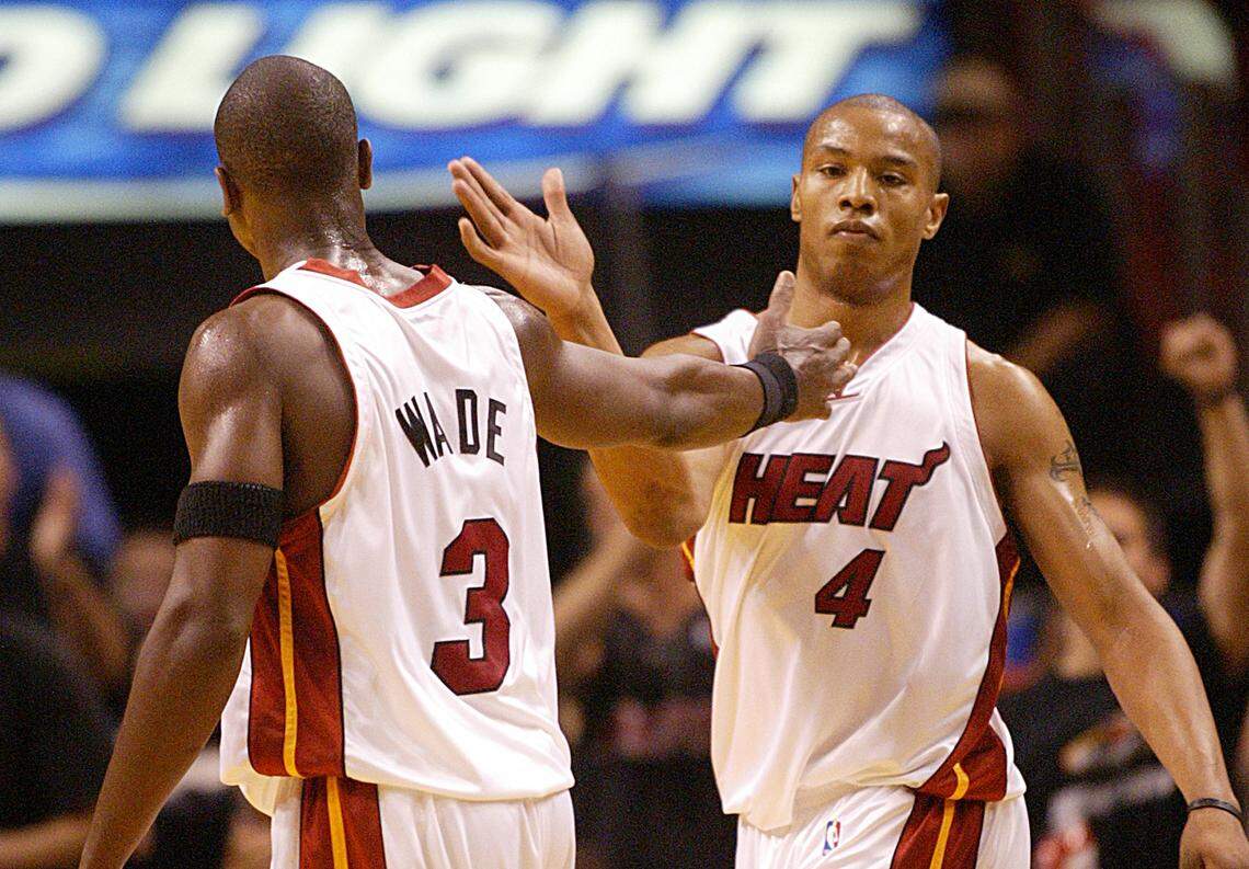 Dwayne Wade and Caron Butler celebrate after Wade scores in the closing minutes of the fourth quarter and the Heat beat the Hornets in the first game of their first round playoff series on April 18, 2014.