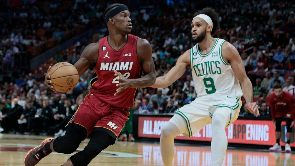 Miami Heat forward Jimmy Butler (22) controls the ball as he goes up against Boston Celtics guard Derrick White (9) in the first half at the FTX Arena in Miami on Friday, October 21, 2022.