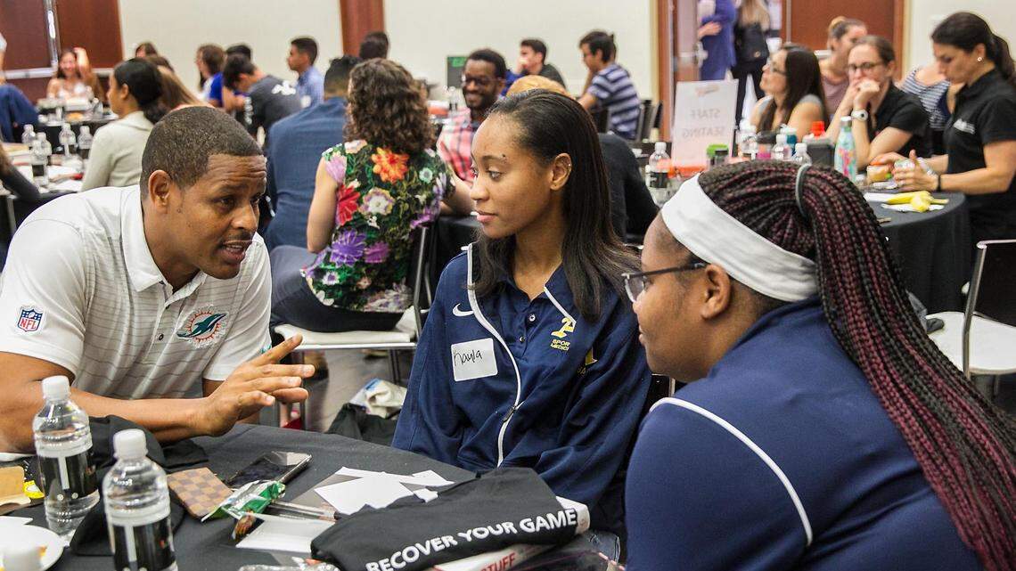 Former Miami Dolphins linebacker Twan Russell chats with Kayla Tillman, 17, and Kayla Scott, 17, during the University of Miami Sports Medicine Institute 9th Annual Student Leadership Day on  Friday, June 22, 2018.