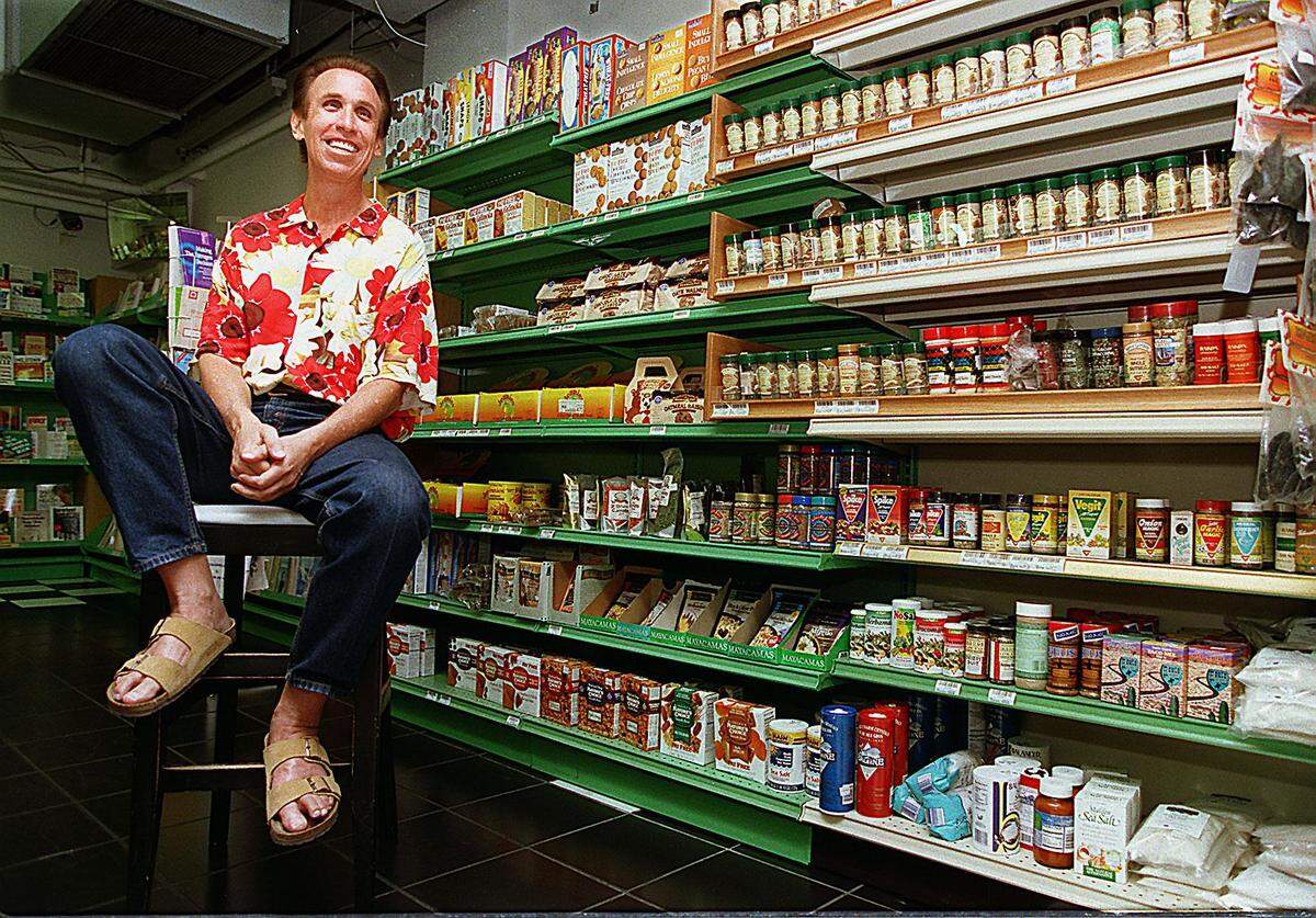 In this file photo from April 18, 1997, Sandy Pukel, owner of the Oak Feed health food store in Coconut Grove, sat in front of the cookie display which had been shrinking at the time because Pukel refused to sell anything with sugar in it. Oak Feed closed in 2004.