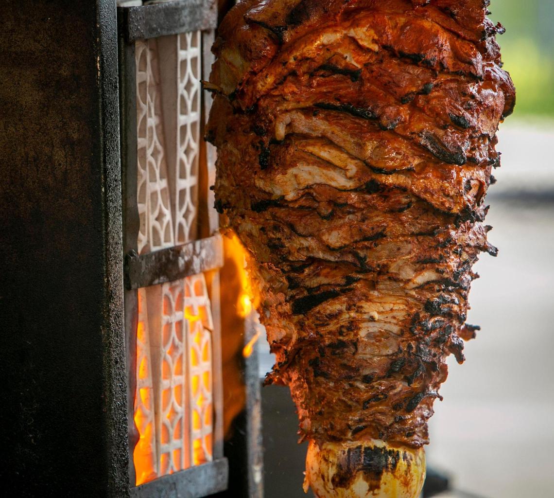Meat cooks on a vertical spit at Eduardo Lara’s taco stand in front of J. Wakefield Brewing in Wynwood.