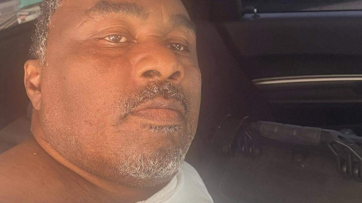 James Edward Daniels, a Miami-Dade County fugitive who was wrongly released from the county jail on Saturday, sits in the back of a police car in Reynolds, Georgia, Wednesday, Oct. 1, 2025.
