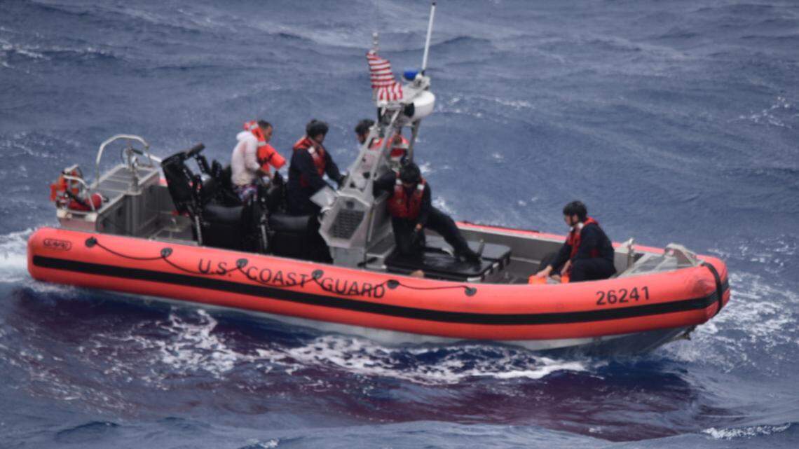 A small boat crew from the Coast Guard Cutter Thetis drives Cuban migrants they rescued Tuesday, July, 6, 2021.