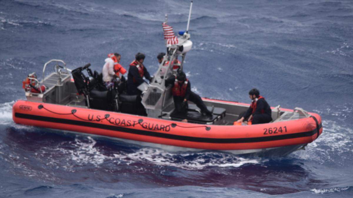 A small boat crew from the Coast Guard Cutter Thetis drives Cuban migrants they rescued Tuesday, July, 6, 2021.