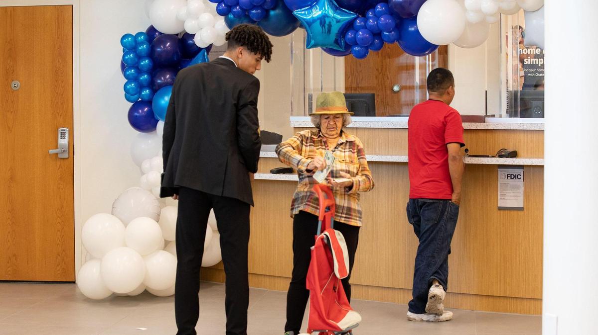 JPMorgan Chase employees assist customers on the opening day at the Little Havana community financial center on Wednesday, June 22, 2022, in Miami.