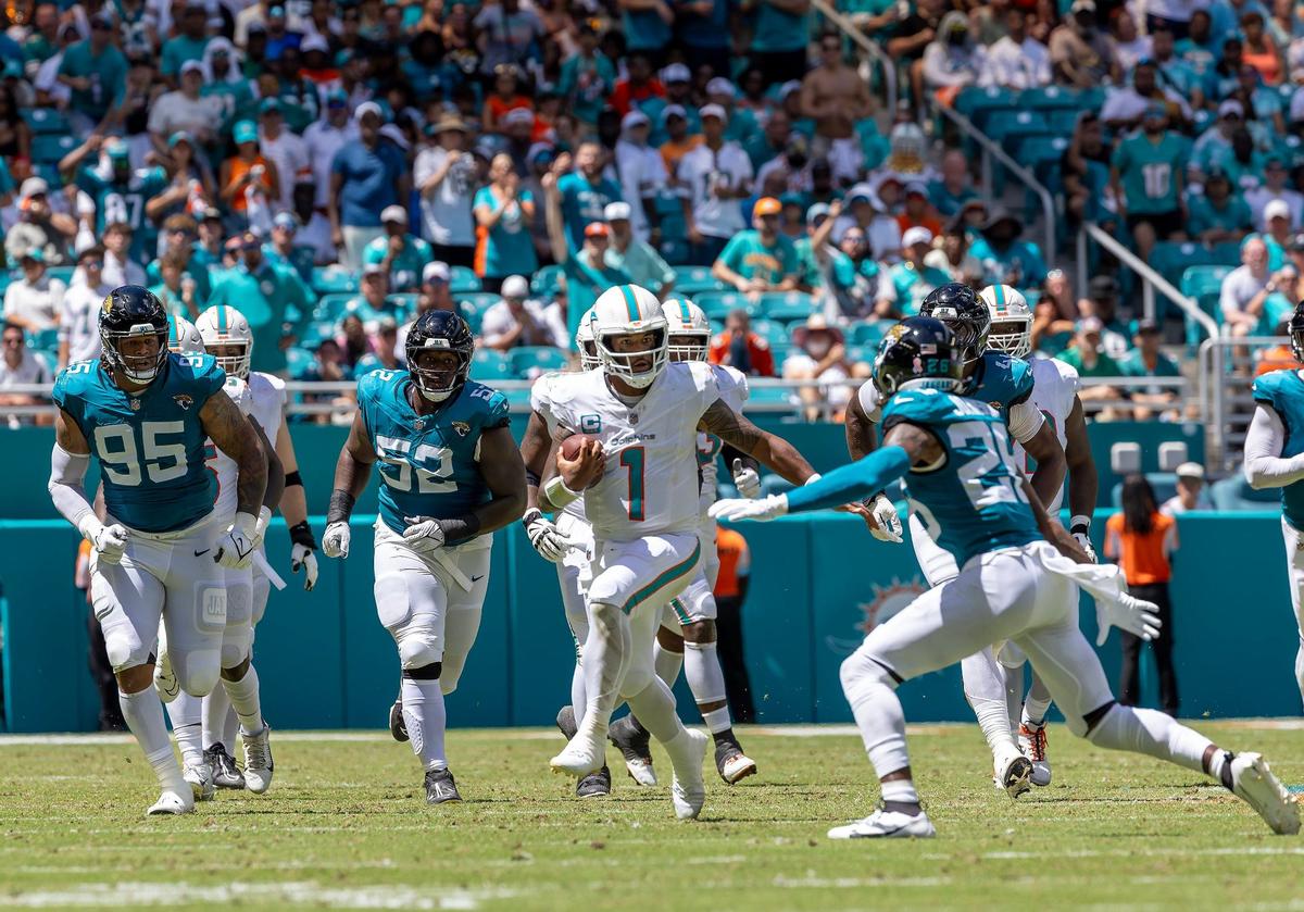 Miami Dolphins quarterback Tua Tagovailoa (1) runs for a first down during the first half of an NFL football game against the Jacksonville Jaguars at Hard Rock Stadium on Sunday, Sep. 8, 2024, in Miami Gardens, Fl.